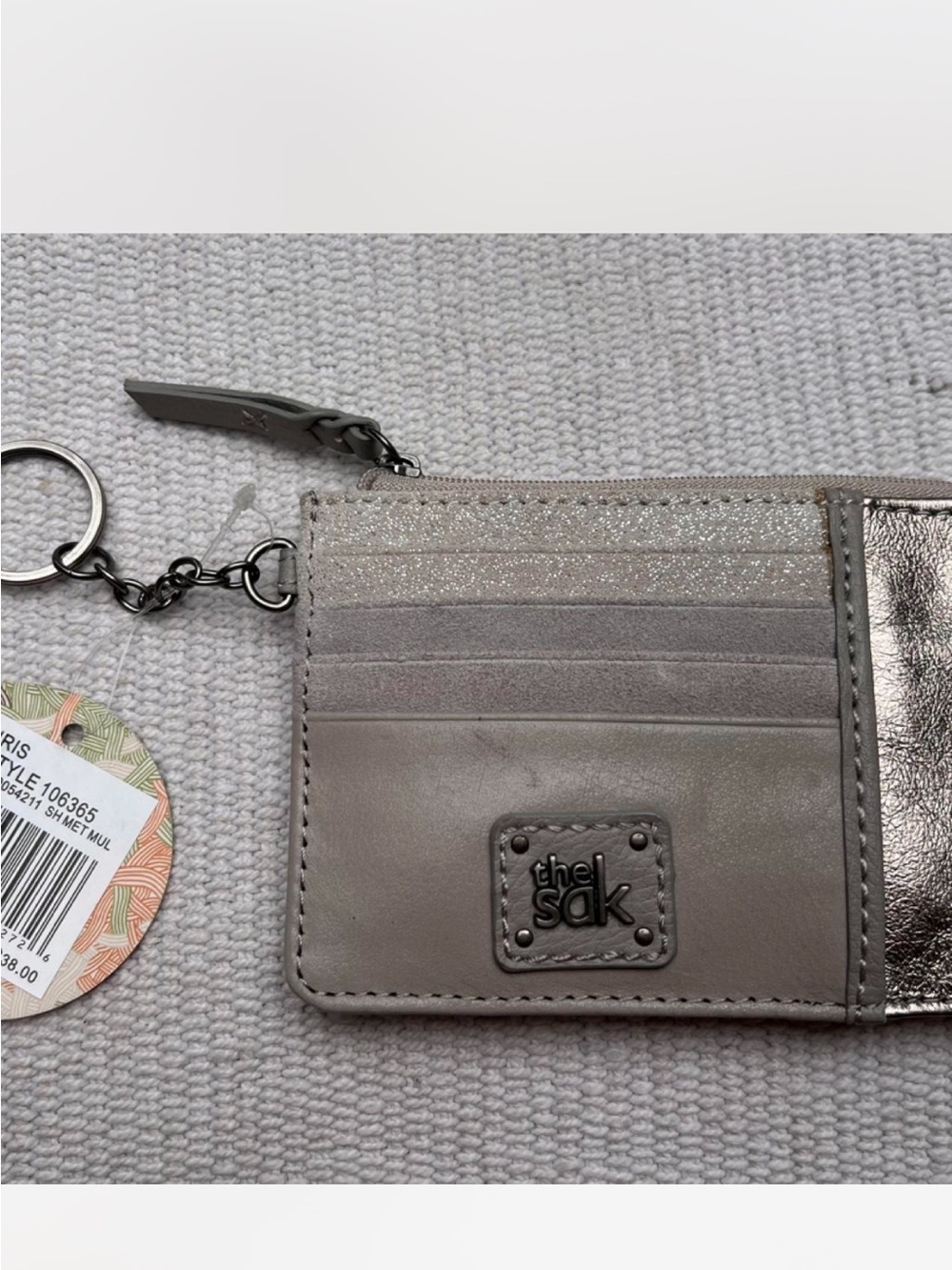The SAK wallet NWT grey and golf with colorful lining. no flaws.